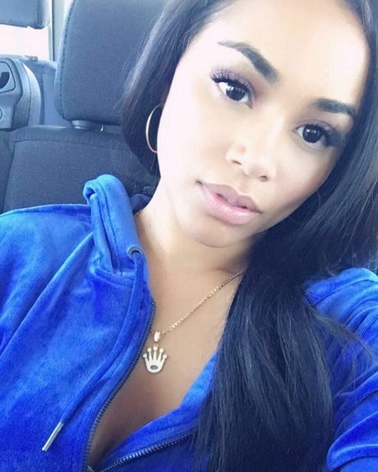 Lauren London posing for a selfie inside a car.